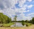 Un espace vert avec un chemin de terre et un lac