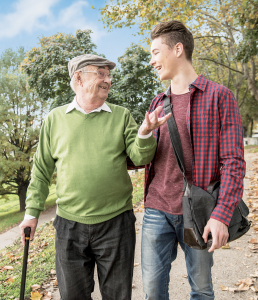 Senior man and adult grandson in park